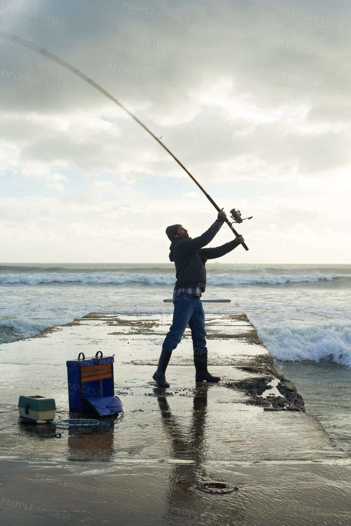 Buy stock photo Fishing, fisherman and man on pier by ocean with rod, reel and equipment to catch fish for hobby. Nature, sports and person cast a line for recreation or adventure on holiday, vacation and weekend