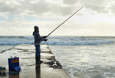 Buy stock photo Fishing, fisherman and man on pier by sea with rod, reel and equipment to catch fish for hobby. Nature, sports and person cast a line for recreation or adventure on holiday, vacation and weekend