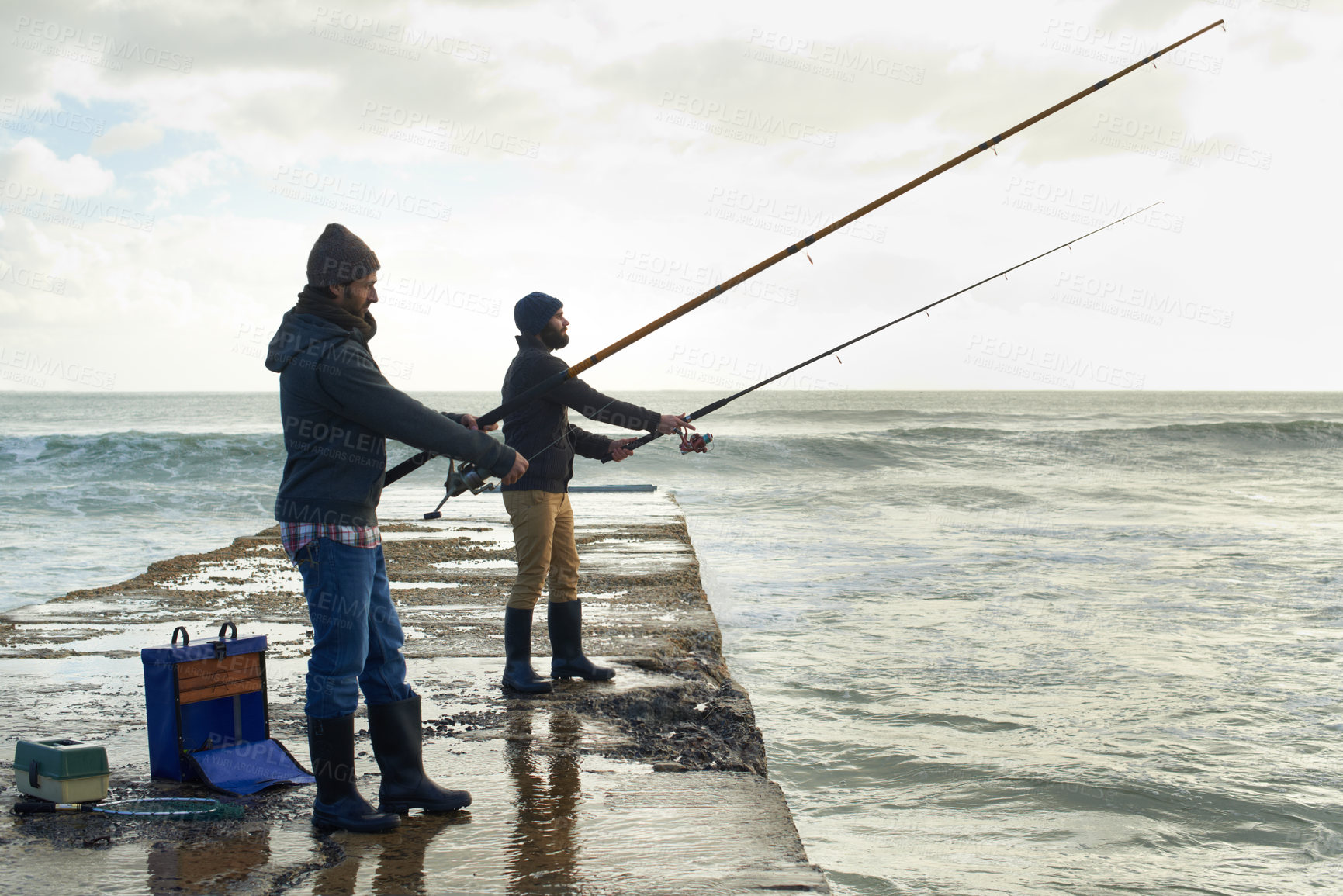 Buy stock photo Fishing, friends and travel with men at beach for adventure, holiday and hobby break. Sunset, calm and patience with male fisherman and casting rod pole in nature for recreation, view and vacation