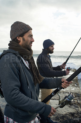 Buy stock photo People, fishing and friends on trip at beach, relaxing and casting a line by ocean waves. Men, fisherman and cloudy sky on vacation or holiday, hobby and bonding by water and support on adventure