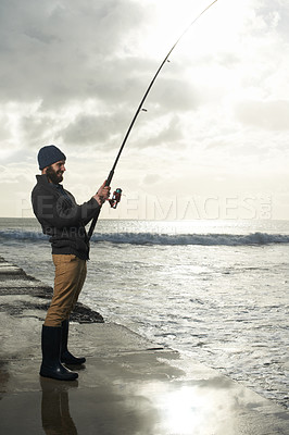 Buy stock photo Fishing, holiday and travel with man at beach for adventure, relax and hobby break. Sunset, calm and patience with male fisherman and casting rod pole in nature for recreation, view and vacation