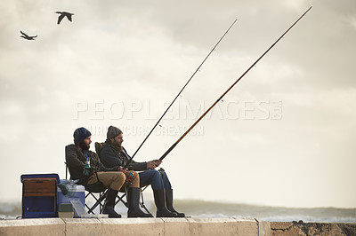 Buy stock photo Sea, pole for fishing and men outdoor in winter, leisure activity at beach or harbor with friends in nature for seafood. Travel, ocean and waves with fisherman, recreation or hobby in the cold