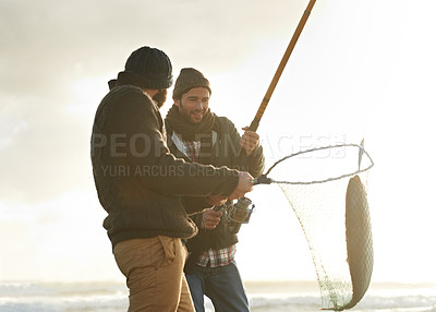 Buy stock photo Fishing, men and net with fish at beach with rod, water and relax on vacation, holiday and travel. Friendship, people and bonding in morning with overcast, sky and nature for activity and hobby