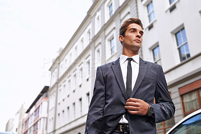 Buy stock photo Businessman, buildings and vision for travel to job, corporate or company in city. Professional man, suit and tie with confidence outdoors for idea, thinking and planning in Australia from low angle