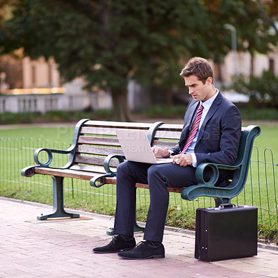 Buy stock photo Park, bench and business man with a laptop, typing and connection with deadline or online reading. Person, employee or entrepreneur with a computer or thinking with check project schedule or internet