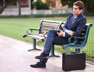 Buy stock photo Businessman, thinking and bench with briefcase in park for relaxing, waiting or fresh air in morning. Professional person, sitting and planning for day with vision, idea or rest in nature on mockup