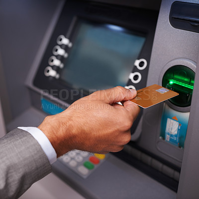Buy stock photo Cropped shot of a businessman inserting his bank card at an ATM