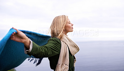 Buy stock photo Shot of a beautiful young woman standing at the ocean