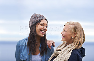 Buy stock photo Friends, laughing and women by ocean for adventure on holiday, vacation and weekend outdoors. Nature, travel and people talking by seaside for relaxing, happiness and bonding together in countryside