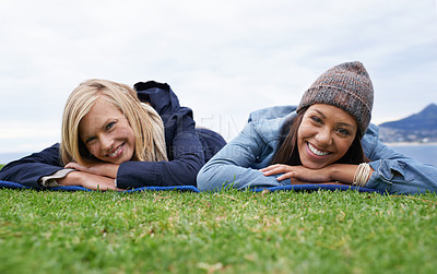 Buy stock photo Picnic, grass and portrait of women relax in field with smile, happy and relax on weekend outdoors. Friends, countryside and people in meadow for bonding on holiday, vacation and adventure in nature