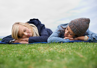 Buy stock photo Sleeping, grass and women relax in field with smile, happy and resting on weekend outdoors. Friends, countryside and people lying in meadow for bonding on holiday, vacation and adventure in nature