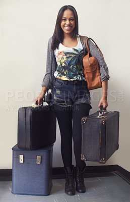 Buy stock photo A young woman holding suitcases - portrait