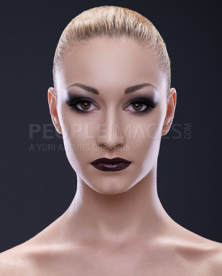 Buy stock photo Cropped portrait of a young woman wearing dark makeup