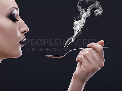 Buy stock photo Makeup, hot and woman blowing a spoon with steam in studio with gothic, cool and danger aesthetic. Mockup, art and female posing with smoke and utensil creative, punk and edgy on black background