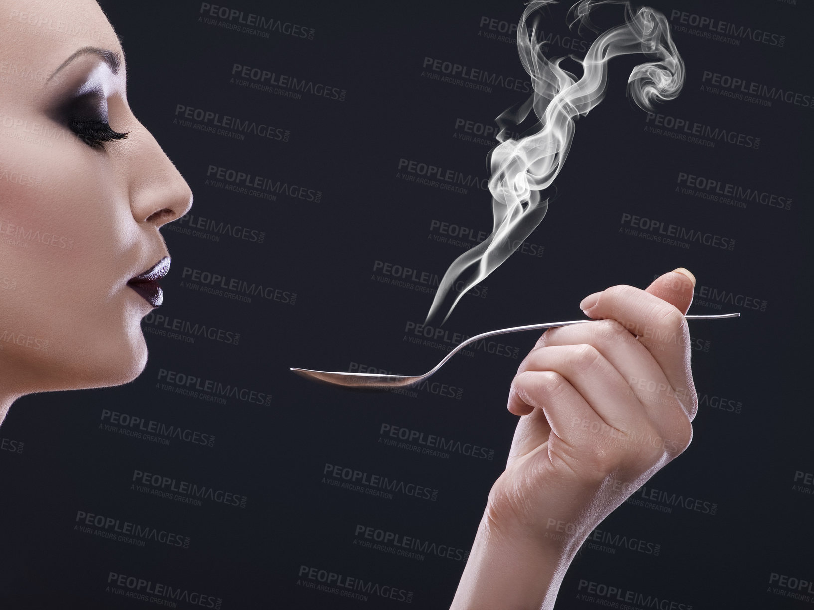 Buy stock photo Makeup, hot and woman blowing a spoon with steam in studio with gothic, cool and danger aesthetic. Mockup, art and female posing with smoke and utensil creative, punk and edgy on black background