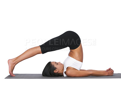 Buy stock photo A young woman doing stretches while isolated on white