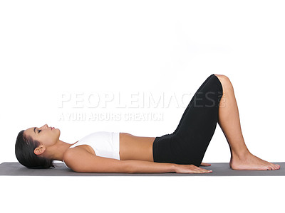 Buy stock photo A young woman doing stretches while isolated on white