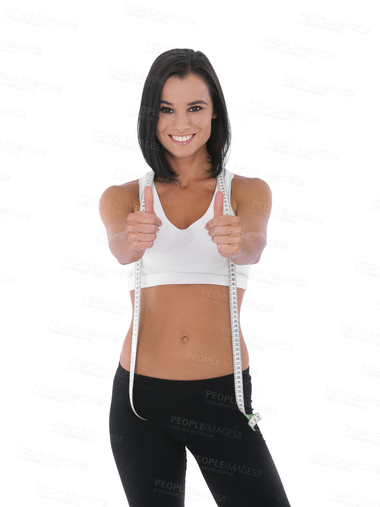 Buy stock photo A fit young woman giving two thumbs up while isolated on white with a measuring tape around her neck