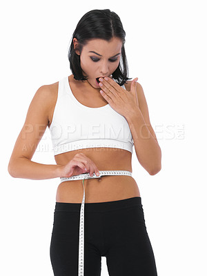 Buy stock photo Shocked woman, tape measure and weight loss of waist for slim body or diet on a white studio background. Surprised female person, athlete or healthy model checking size or waistline on mockup space