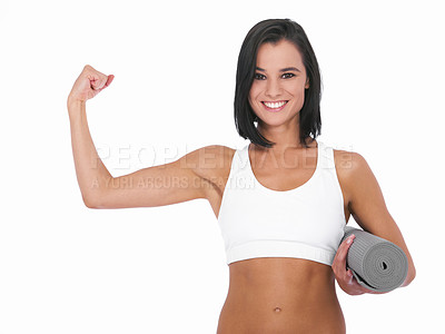 Buy stock photo A healthy young woman smiling and showing a bicep while holding a yoga mat - Isolated on white