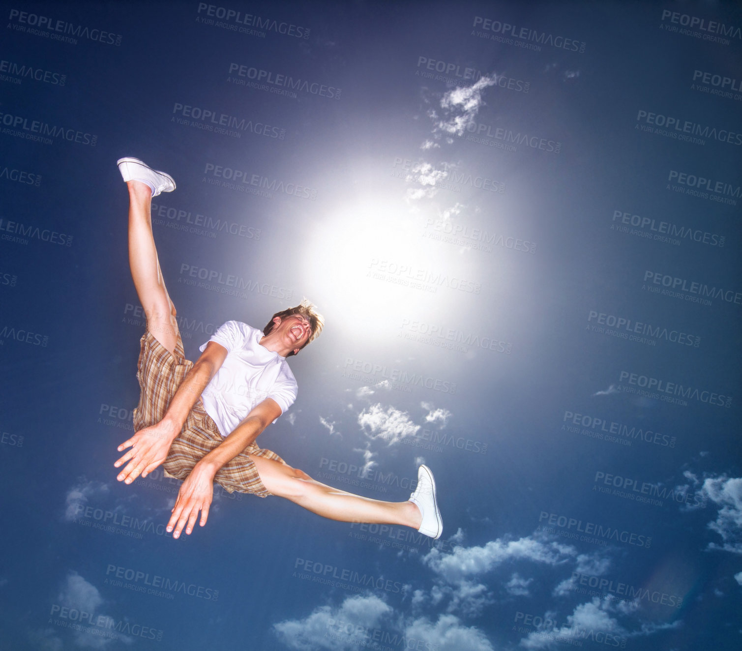 Buy stock photo Boy, blue sky and jump outdoor with low angle, energy and lens flare of sunshine. Young teenager, below and leap in air by clouds in summer, moving and kid screaming for freedom with agile action