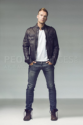 Buy stock photo Man, fashion and biker clothes in portrait, sexy and confident with cool outfit isolated on studio background. Full body, leather jacket and jeans with serious male model, masculine style and edgy 