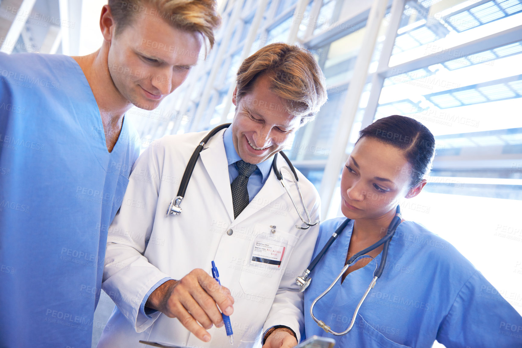 Buy stock photo A medical team standing in the hospital corridor