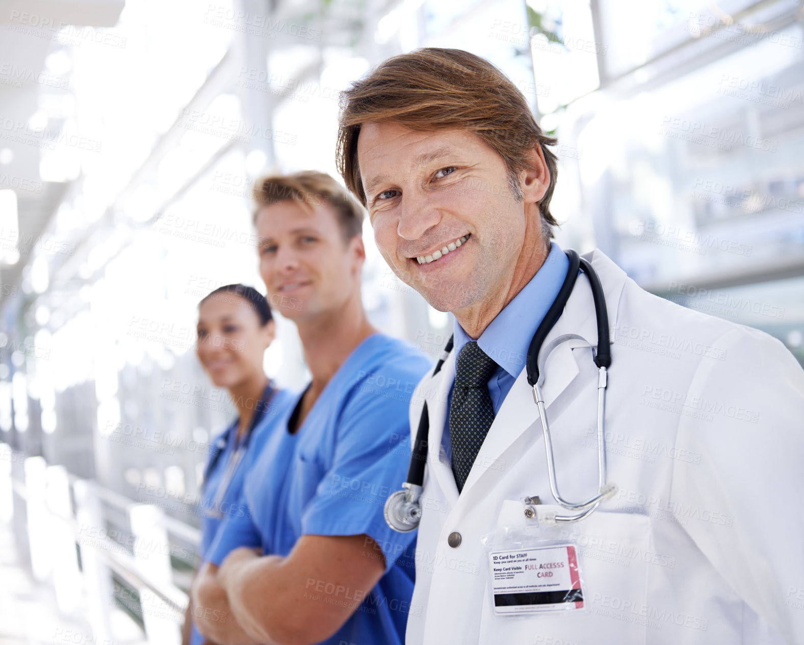 Buy stock photo A medical team standing in the hospital corridor