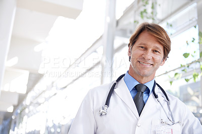 Buy stock photo A medical doctor standing in a hospital corridor