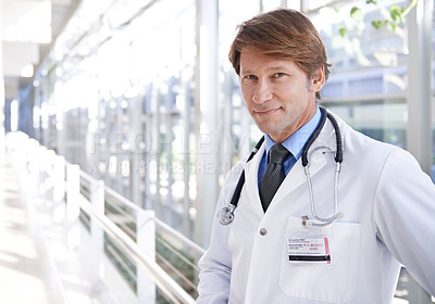 Buy stock photo Smile, pride and portrait of doctor in hospital with positive, good and confident attitude. Happy, medical career and face of professional mature male healthcare worker in medicare clinic corridor.