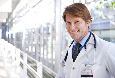 Buy stock photo Happy, pride and portrait of doctor in hospital with positive, good and confident attitude. Smile, medical career and face of professional mature male healthcare worker in medicare clinic corridor.