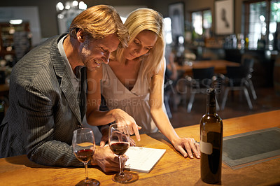 Buy stock photo Shot of a couple enjoying a wine tasting