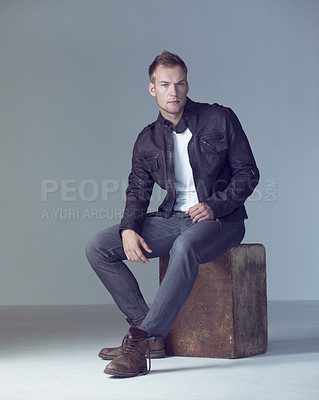 Buy stock photo Portrait, man and fashion with chair and style or jeans in studio and casual outfits. Stylish make, serious face and cool with trendy clothes with confidence, denim, boots, handsome or attractive.
