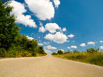 Buy stock photo Countryside road, outdoor landscape and sky with clouds, summer sunshine and background in nature. Street, asphalt and spring with mockup space, trees and plants from low angle in natural environment