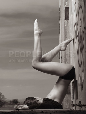 Buy stock photo Woman, ballet and dance with feet on wall with graffiti for art, expression and movement outdoors. Female dancer, creative and legs for contemporary, performance and wellness with freedom in Brazil