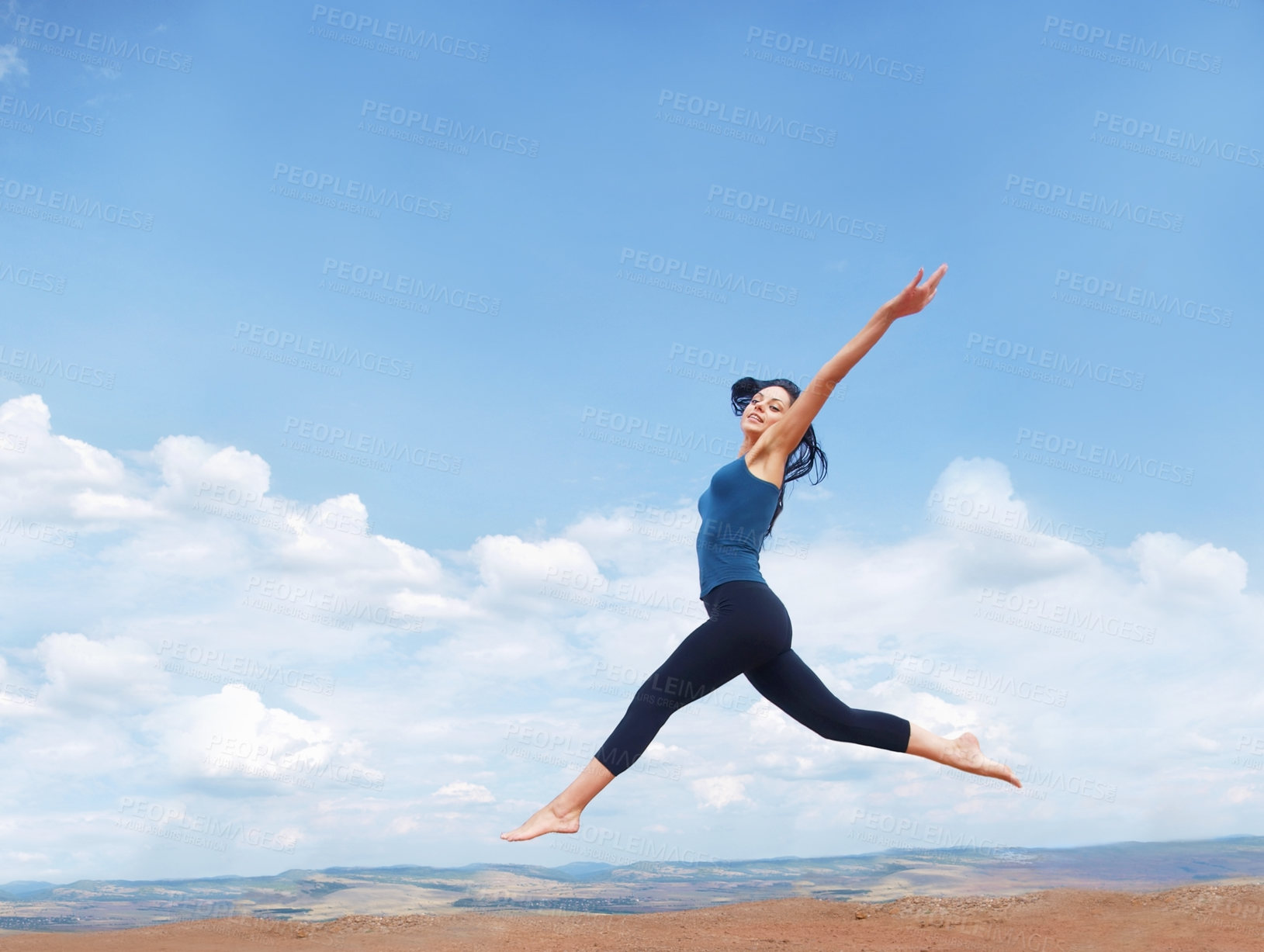 Buy stock photo Shot of a beautiful young woman leaping enthusiastically during a workout outdoors 