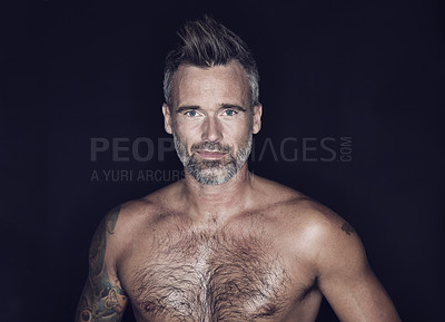 Buy stock photo Mature man, portrait and model confidence in the dark with tattoo and strong muscles in studio. Male person, muscular and topless with black background and smile from fitness, toned body and pose