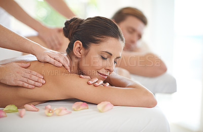 Buy stock photo A husband and wife lying receiving massages at a spa
