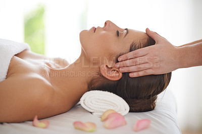 Buy stock photo Side view of a young woman receiving a head massage at a spa