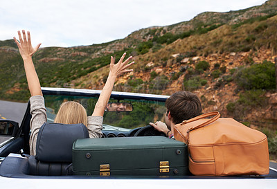 Buy stock photo Rear view of a couple taking a road trip in a convertible