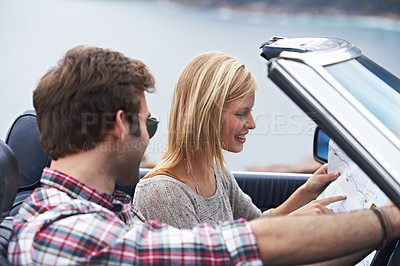Buy stock photo Map, travel and couple in a car for transportation to vacation, adventure or holiday destination. Reading, navigating guide and people on journey in vehicle driving for weekend road trip together.