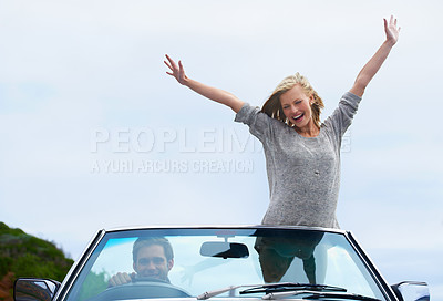 Buy stock photo Shot of a young couple enjoying a road trip