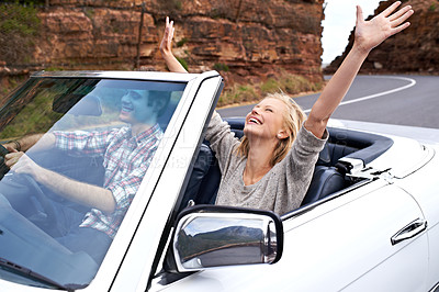 Buy stock photo Shot of a happy couple enjoying a road trip