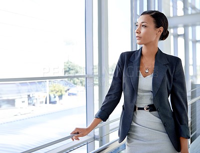 Buy stock photo A thoughtful businesswoman gazing out of the window