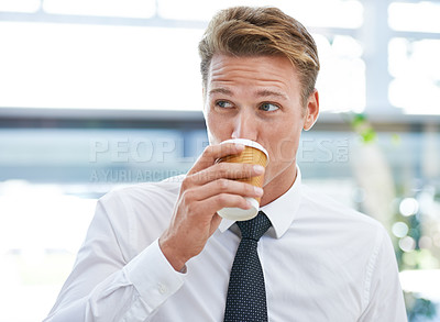 Buy stock photo A young businessman drinking a cup of coffee