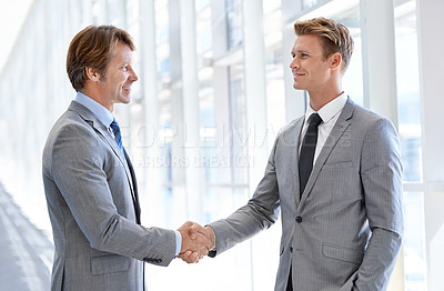 Buy stock photo Shot of two professional colleagues in an office building