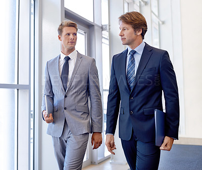 Buy stock photo Men, business and walking in office building with paperwork or project, meeting or corporate. Male people, colleagues and documents in hallway in London for teamwork, collaboration or professional