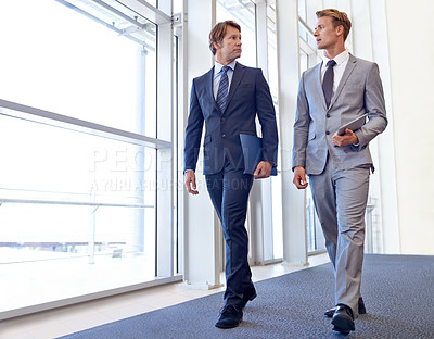 Buy stock photo Two businessmen having a chat on the go.