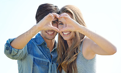 Buy stock photo Shot of a positive and loving young couple standing outside