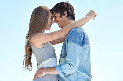 Buy stock photo A young couple standing face to face outdoors